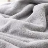 A close-up view of a soft, gray, fluffy fabric, likely a towel or blanket. Produktbild-Vorschau