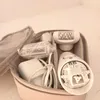 An epilator and its accessories are neatly arranged inside a light-colored carrying case. Náhľad obrázku produktu