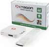 A white Octagon Spirit White 4K UHD Android TV Box with its remote and packaging are displayed on a white background. Produktbild-Vorschau