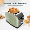A toaster with two slices of toast in it, placed on a white surface with some baked goods in the background. Anteprima dell’immagine prodotto
