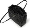 A black quilted tote bag with its interior compartments visible. Produktbild-Vorschau