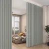 A bedroom divided by a light gray vertical blind curtain. Anteprima dell’immagine prodotto
