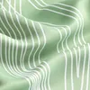 A close-up shot of a green fabric with a white wavy line pattern. Produktbild-Vorschau