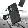 A black phone case is shown on a textured surface, with debris scattered around it, suggesting it has been dropped. Produktbild-Vorschau