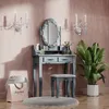 A vanity table with a mirror, stool, and plant in a room. Produktbild-Vorschau
