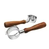 Two coffee portafilters with wooden handles are shown against a white background. Náhled obrázku produktu