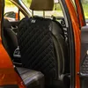 The image shows the back of a car seat with a black quilted seat protector attached. Produktbild-Vorschau