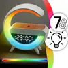 A bedside lamp with a digital clock and wireless charging pad, displaying a rainbow of colors. Podgląd zdjęcia produktu