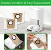 A white robot vacuum cleaner with its charging station, and several dust bags for replacement. The image also includes close-up shots of hands replacing the dust bags. Produktbild-Vorschau