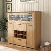 A wooden sideboard with a glass display cabinet and wine rack, set against a paneled wall. Anteprima dell’immagine prodotto