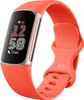A Fitbit Charge 6 fitness tracker with a coral band and champagne-colored accents. Náhled obrázku produktu