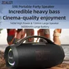 A portable speaker is placed on a beach with people in the background. Produktbild-Vorschau