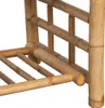 A close-up view of the bamboo structure of a table, showing the legs and shelving. Náhled obrázku produktu