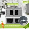 A two-story rabbit hutch in a snowy outdoor environment, with marketing text and overlays. Produktbild-Vorschau