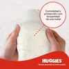 Hands holding a Huggies diaper with a red circle overlay containing marketing text. Náhľad obrázku produktu