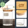 A collage of images showcasing a glass storage jar with a bamboo lid, with close-ups of the lid and the jar's base. Produktbild-Vorschau