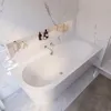 A modern bathroom with a white bathtub and marble walls. Produktbild-Vorschau