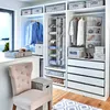 A well-organized walk-in closet with various storage solutions, including hanging clothes, shelves, drawers, and fabric storage bins. Anteprima dell’immagine prodotto
