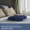 A dark blue butterfly-shaped pillow on a bed with other pillows and curtains. Produktbild-Vorschau