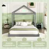 A child's bed in a room with green and white walls, decorated with pillows and a small bedside table. Produktbild-Vorschau