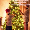 Two children in Santa hats decorating a Christmas tree. Náhled obrázku produktu