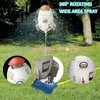 A rocket-shaped sprinkler spraying water in a garden. Produktbild-Vorschau