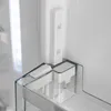 A close-up view of the interior of a refrigerator, showing a clear plastic shelf and a white component attached to the side wall. Produktbild-Vorschau
