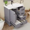 A bathroom vanity with a sink and faucet, showing open drawers with various bathroom items inside. Anteprima dell’immagine prodotto