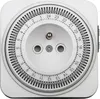A white electrical timer outlet with a circular dial showing hours from 1 to 24. Náhľad obrázku produktu