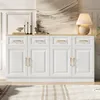 A white sideboard buffet with gold handles, decorated with candles, books, and a lamp, placed in a room with a painting on the wall and a rug on the floor. Anteprima dell’immagine prodotto