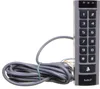 A close-up studio shot of a gray and black keypad with a coiled gray cable attached. Voir les images du produit