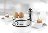 A stainless steel electric egg cooker with a lid, eggs, and egg cups on a white reflective surface with a blurred background. Produktbild-Vorschau