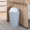 A gray trash can with a white lid is placed under a wooden counter in a kitchen. Produktbild-Vorschau