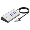 A silver USB-C hub with multiple ports and a black cable is shown on a white background. Produktbild-Vorschau