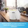 A white bucket filled with apples sits on a wooden countertop next to a window. Voir les images du produit