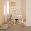 A young child sits inside a wooden indoor play structure in a room with soft lighting and decor. Anteprima dell’immagine prodotto