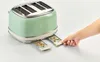 A child's hand is pulling out two crumb-filled toast racks from a green retro-style toaster. Produktbild-Vorschau