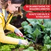 A woman gardening in a raised garden bed. Produktbild-Vorschau