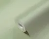 A roll of green textured wallpaper. Produktbild-Vorschau
