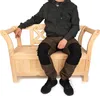 A person sitting on a wooden bench. Produktbild-Vorschau