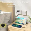 A digital alarm clock is shown on a nightstand next to a bed, charging a smartphone. The clock displays the time and has a mirrored surface. A power adapter is plugged into a wall socket. Produktbild-Vorschau