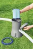 A person is inserting a filter into a pool pump on a grassy lawn. Produktbild-Vorschau