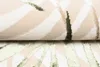 A close-up view of a folded rug with a modern abstract pattern. Náhľad obrázku produktu