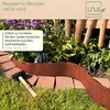 A rusty metal garden edging is installed in a garden bed with flowers and grass. Produktbild-Vorschau