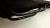 A close-up view of a black bicycle saddle's metal rails, showing measurement markings. Produktbild-Vorschau
