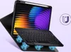A tablet with a keyboard case, displaying a colorful wallpaper and a magnetic charging icon. Produktbild-Vorschau