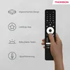 A hand holding a black remote control with various icons and text describing its features on a light gray background. Produktbild-Vorschau
