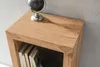 A close-up of a wooden shelf with books and a globe. Produktbild-Vorschau