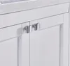 A close-up view of two chrome cabinet handles on a white bathroom vanity. Náhled obrázku produktu