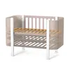 A baby crib with a velour lining, shown against a white background. Produktbild-Vorschau